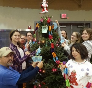 Decorating tree at Hometown Christmas for needy family. 
